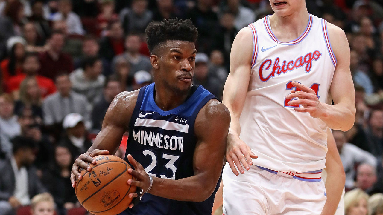 CHICAGO, IL - FEBRUARY 09: Jimmy Butler #23 of the Minnesota Timberwolves drives around Lauri Markkanen #24 of the Chicago Bulls at the United Center on February 9, 2018 in Chicago, Illinois. The Bulls defeated the Timberwolves 114-113.