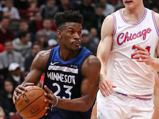 CHICAGO, IL - FEBRUARY 09: Jimmy Butler #23 of the Minnesota Timberwolves drives around Lauri Markkanen #24 of the Chicago Bulls at the United Center on February 9, 2018 in Chicago, Illinois. The Bulls defeated the Timberwolves 114-113.