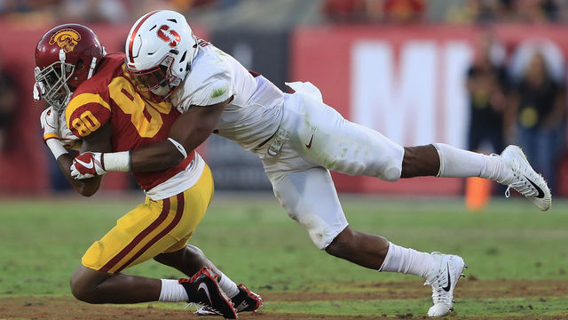 LOS ANGELES, CA - SEPTEMBER 09: Justin Reid #8 of the Stanford Cardinal tackles Deontay Burnett #80 of the USC Trojans during the first half at Los Angeles Memorial Coliseum on September 9, 2017 in Los Angeles, California.