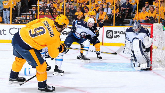 NASHVILLE, TN - APRIL 27: Filip Forsberg #9 of the Nashville Predators takes a shot on goalie Connor Hellebuyck #37 of the Winnipeg Jets during the first period in Game One of the Western Conference Second Round during the 2018 NHL Stanley Cup Playoffs at Bridgestone Arena on April 27, 2018 in Nashville, Tennessee.