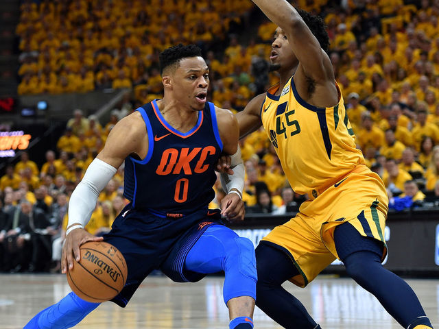 SALT LAKE CITY, UT - APRIL 27: Donovan Mitchell #45 of the Utah Jazz guards against Russell Westbrook #0 of the Oklahoma City Thunder in the first half during Game Six of Round One of the 2018 NBA Playoffs at Vivint Smart Home Arena on April 27, 2018 in Salt Lake City, Utah.