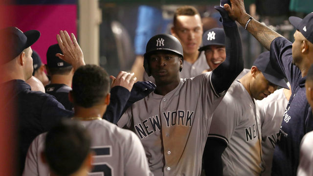 ANAHEIM, CA - APRIL 27: Didi Gregorius #18 of the New York Yankees celebrates in the dugout with teammates after hitting a solo and eventual game-winning homerun in the tenth inning for the 4-3 lead in their MLB game against the Los Angeles Angels of Anaheim at Angel Stadium on April 27, 2018 in Anaheim, California. The Yankees defeated the Angels 4-3 in ten innings.
