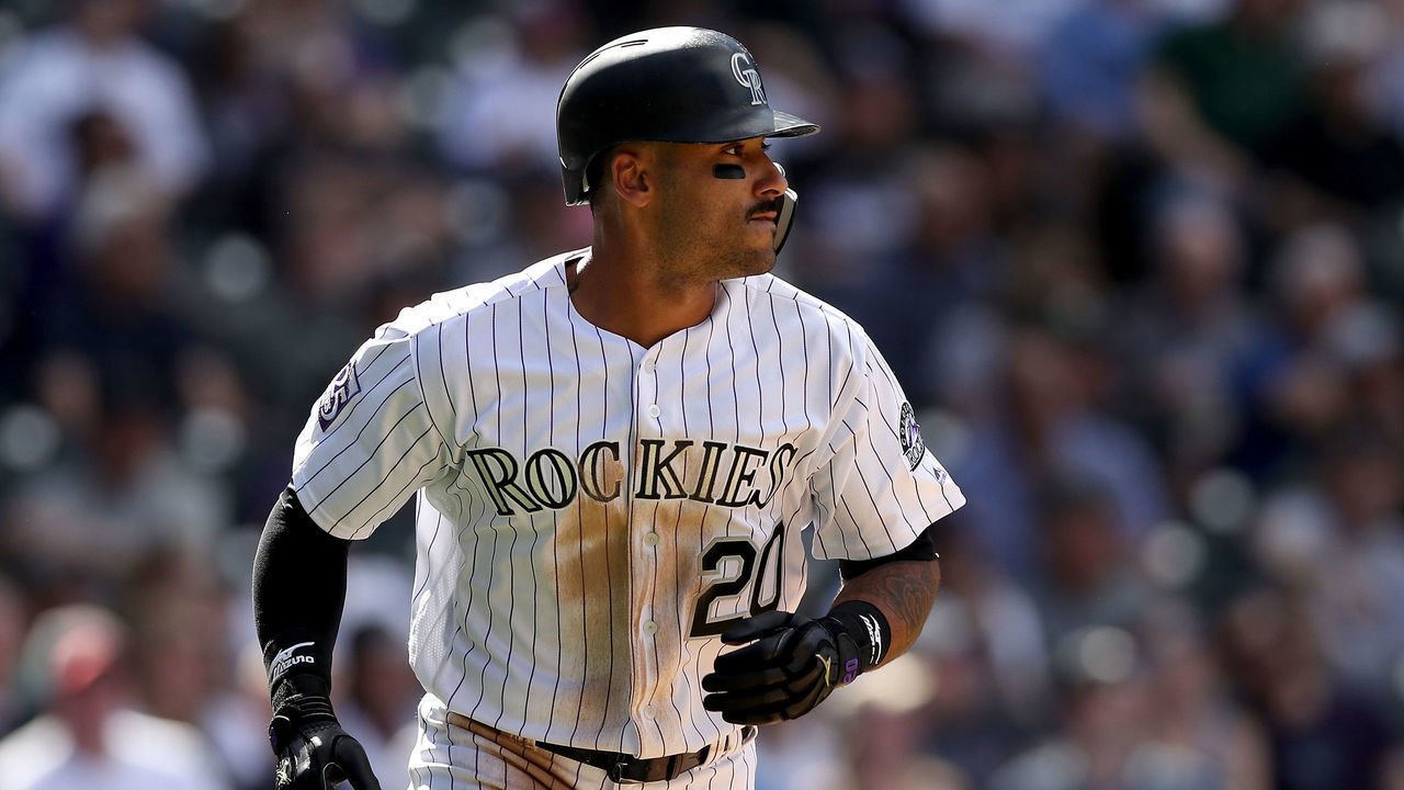 DENVER, CO - APRIL 11: Ian Desmond #20 of the Colorado Rockies hits a RBI sacrifice fly the sixth inning against the San Diego Padres at Coors Field on April 11, 2018 in Denver, Colorado.