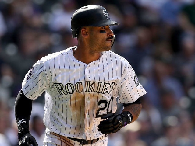 DENVER, CO - APRIL 11: Ian Desmond #20 of the Colorado Rockies hits a RBI sacrifice fly the sixth inning against the San Diego Padres at Coors Field on April 11, 2018 in Denver, Colorado.