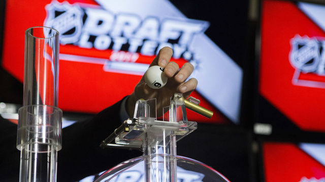 TORONTO, ON - APRIL 29: NHL official loads the lottery ball machine during the NHL Draft Lottery at the CBC Studios in Toronto, Ontario, Canada on April 29, 2017.