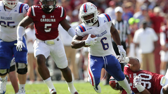 COLUMBIA, SC - SEPTEMBER 23: Boston Scott #6 of the Louisiana Tech Bulldogs runs away from Taylor Stallworth #90 of the South Carolina Gamecocks during their game at Williams-Brice Stadium on September 23, 2017 in Columbia, South Carolina.