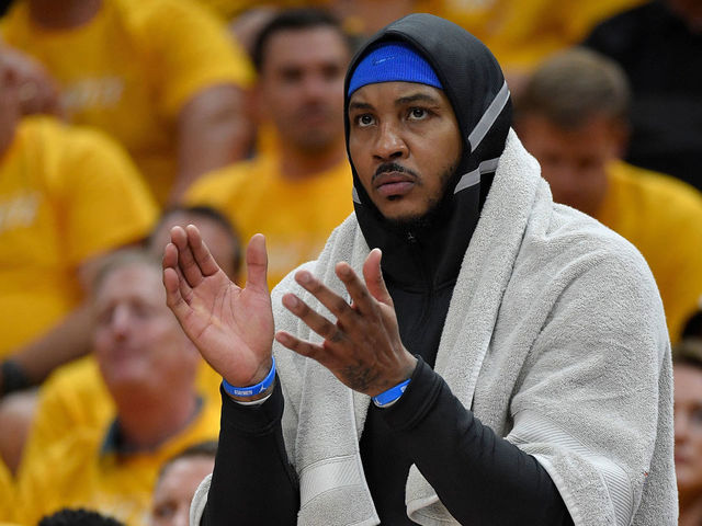 SALT LAKE CITY, UT - APRIL 21: Carmelo Anthony #7 of the Oklahoma City Thunder cheers from the bench in the first half during Game Three of Round One of the 2018 NBA Playoffs against the Utah Jazz at Vivint Smart Home Arena on April 21, 2018 in Salt Lake City, Utah.