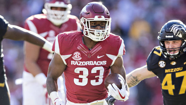 FAYETTEVILLE, AR - NOVEMBER 24: David Williams #33 of the Arkansas Razorbacks runs the ball in for a touchdown during a game against the Missouri Tigers at Razorback Stadium on November 24, 2017 in Fayetteville, Arkansas.
