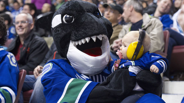 VANCOUVER, CANADA - MARCH 19: Vancouver Canucks mascot Fin holds Emmanuella Dykes during the third period in NHL action on March 19, 2013 at Rogers Arena in Vancouver, British Columbia, Canada.