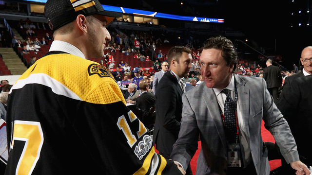 CHICAGO, IL - JUNE 24: Cedric Pare greets John Ferguson Jr. after being selected 173rd overall by the Boston Bruins during the 2017 NHL Draft at United Center on June 24, 2017 in Chicago, Illinois.
