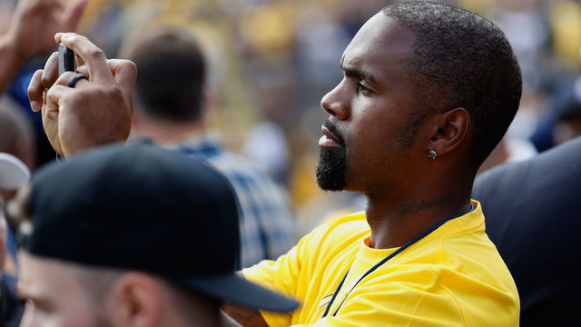 ANN ARBOR, MI - SEPTEMBER 03: Former Michigan cornerback Charles Woodson takes a photo prior to a game between the Michigan Wolverines and Hawaii Warriors on September 3, 2016 at Michigan Stadium in Ann Arbor, Michigan.