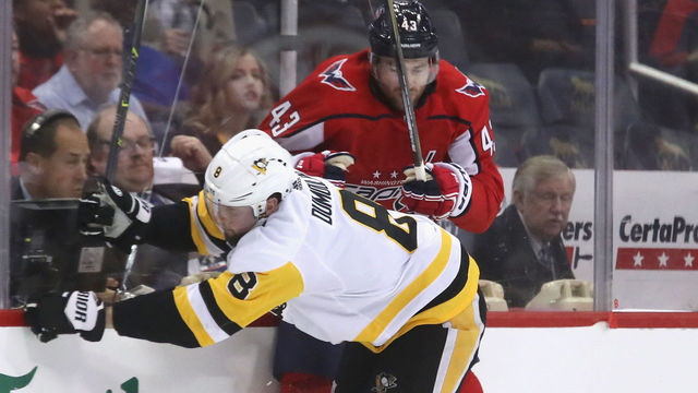 WASHINGTON, DC - APRIL 26: Brian Dumoulin #8 of the Pittsburgh Penguins checks Tom Wilson #43 of the Washington Capitals into the boards during the second period in Game One of the Eastern Conference Second Round during the 2018 NHL Stanley Cup Playoffs at the Capital One Arena on April 26, 2018 in Washington, DC.