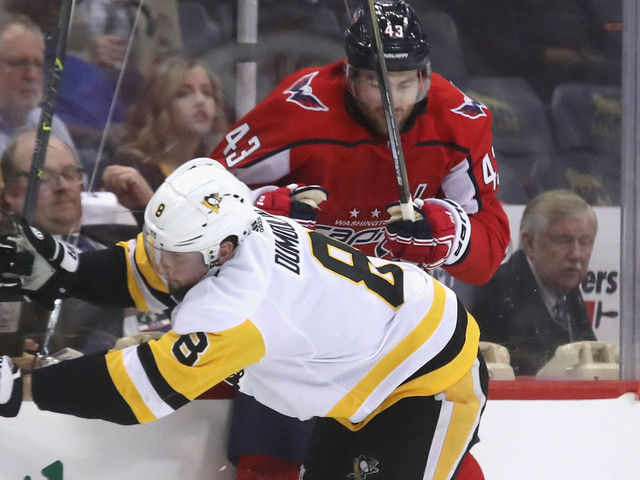 WASHINGTON, DC - APRIL 26: Brian Dumoulin #8 of the Pittsburgh Penguins checks Tom Wilson #43 of the Washington Capitals into the boards during the second period in Game One of the Eastern Conference Second Round during the 2018 NHL Stanley Cup Playoffs at the Capital One Arena on April 26, 2018 in Washington, DC.