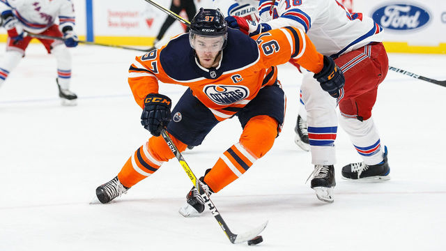 EDMONTON, AB - MARCH 03: Connor McDavid #97 of the Edmonton Oilers evades Marc Staal #18 of the New York Rangers at Rogers Place on March 3, 2018 in Edmonton, Canada.
