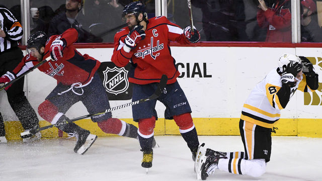 WASHINGTON, DC - APRIL 29: Pittsburgh Penguins defenseman Brian Dumoulin (8) goes to the ice after being hit by Washington Capitals right wing Tom Wilson (43) and left wing Alex Ovechkin (8) on April 29, 2018, at the Capital One Arena in Washington, D.C. in the Second Round of the Stanley Cup Playoffs. The Washington Capitals defeated the Pittsburgh Penguins, 4-1.
