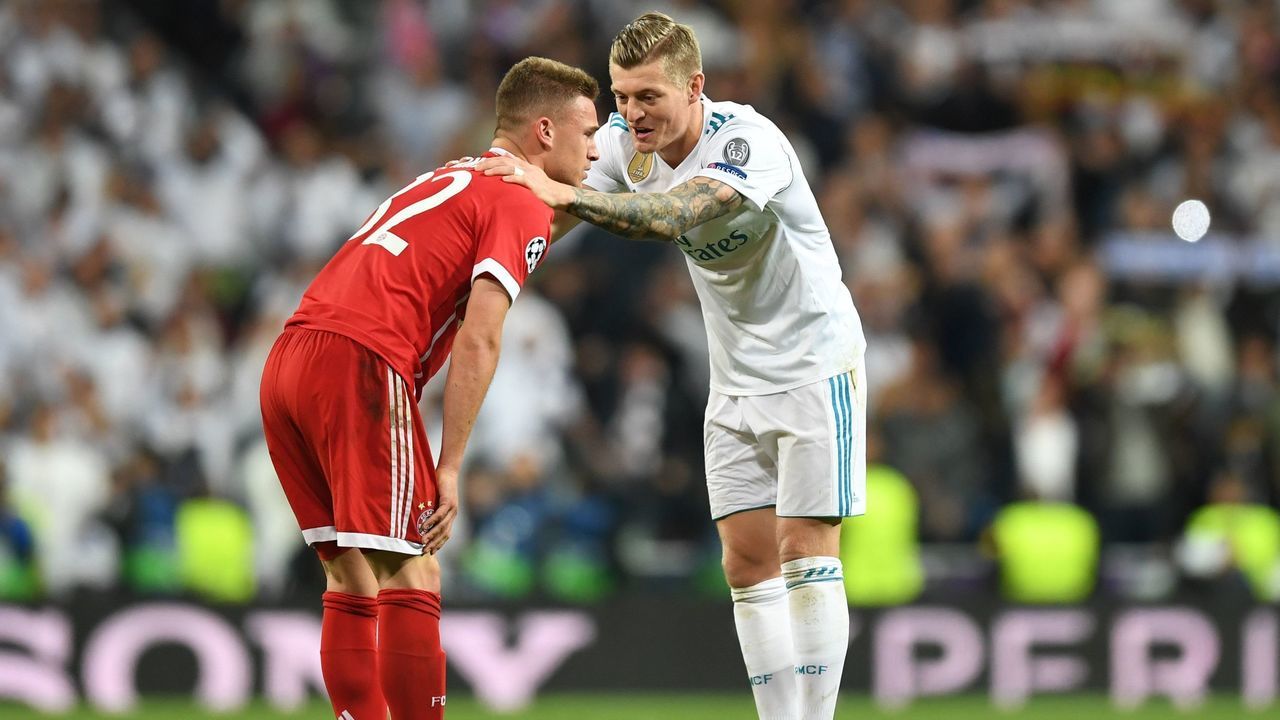 Bayern Munich's German midfielder Joshua Kimmich (L) is comforted by Real Madrid's German midfielder Toni Kroos after the UEFA Champions League semi-final second-leg football match Real Madrid CF vs FC Bayern Munich in Madrid, Spain, on May 1, 2018.