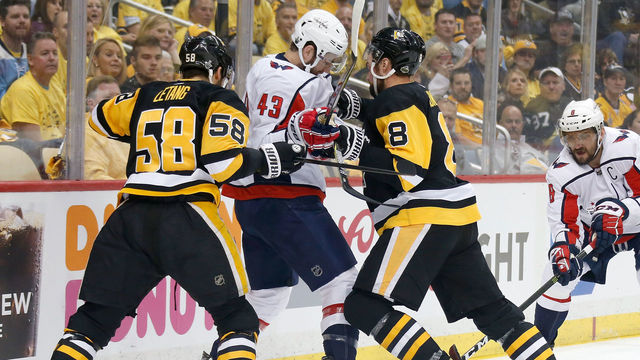 PITTSBURGH, PA - MAY 01: Kris Letang #58 of the Pittsburgh Penguins and Brian Dumoulin #8 of the Pittsburgh Penguins check Tom Wilson #43 of the Washington Capitals while battling for control of the puck during the first period in Game Three of the Eastern Conference Second Round during the 2018 NHL Stanley Cup Playoffs at PPG PAINTS Arena on May 1, 2018 in Pittsburgh, Pennsylvania.