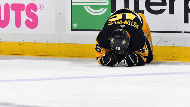 PITTSBURGH, PA - MAY 01: Zach Aston-Reese #46 of the Pittsburgh Penguins lays on the ice after being checked in the head by Tom Wilson #43 of the Washington Capitals (not pictured) in Game Three of the Eastern Conference Second Round during the 2018 NHL Stanley Cup Playoffs at PPG Paints Arena on May 1, 2018 in Pittsburgh, Pennsylvania.