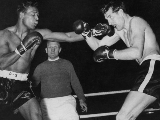 American middleweight boxer Sugar Ray Robinson (1921 - 1989, left) lands a straight left on former German middleweight champion Hans Stretz during a match in Frankfurt, 25th December 1950. Robinson won the fight by technical knock-out in the fifth round.