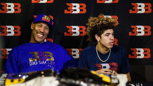 LaVar Ball (L), father of basketball player LiAngelo Ball and the owner of the Big Baller brand, sits with his other son LaMelo Ball during a promotional event in Hong Kong on November 14, 2017. UCLA players LiAngelo Ball -- the younger brother of Los Angeles Lakers rookie star Lonzo Ball -- and teammates Cody Riley and Jalen Hill were arrested on November 7 in Hangzhou ahead of their regular-season-opening game against Georgia Tech in nearby Shanghai this past weekend. ESPN reported that they were nabbed on suspicion of stealing from a Louis Vuitton store and later freed on bail but ordered to remain in Hangzhou. / AFP PHOTO / Anthony WALLACE