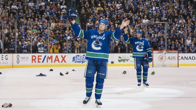 VANCOUVER, BC - OCTOBER 5: Daniel Sedin #22 and Henrik Sedin #33 of the Vancouver Canucks salute the fans after playing in their final home game of their career against the Arizona Coyotes in NHL action on April, 5, 2018 at Rogers Arena in Vancouver, British Columbia, Canada.