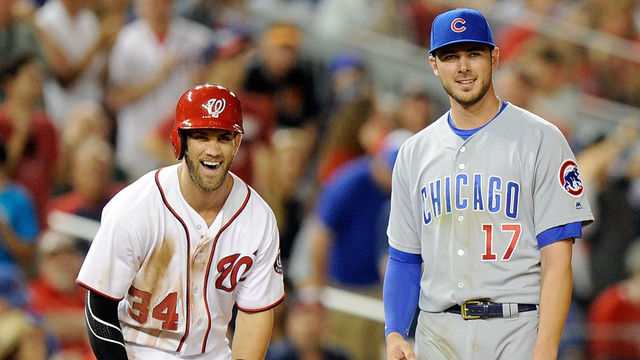 WASHINGTON, DC - JUNE 14: Bryce Harper #34 of the Washington Nationals talks with Kris Bryant #17 of the Chicago Cubs during the eighth inning at Nationals Park on June 14, 2016 in Washington, DC. Chicago won the game 4-3.