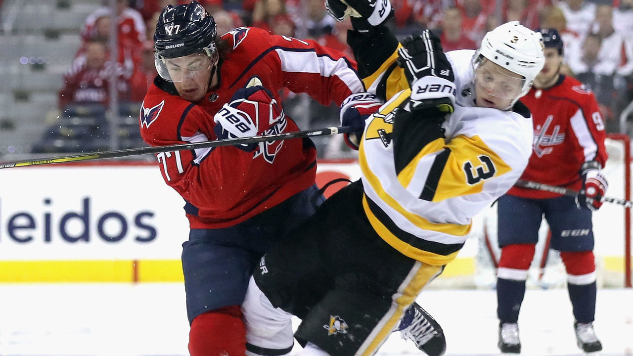 WASHINGTON, DC - APRIL 26: Olli Maatta #3 of the Pittsburgh Penguins is checked by T.J. Oshie #77 of the Washington Capitals during the second period in Game One of the Eastern Conference Second Round during the 2018 NHL Stanley Cup Playoffs at the Capital One Arena on April 26, 2018 in Washington, DC.