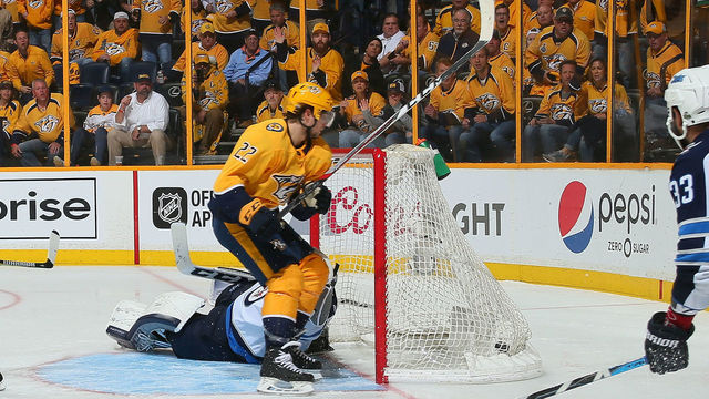 NASHVILLE, TN - APRIL 29: Kevin Fiala #22 of the Nashville Predators scores the game winning goal against goalie Connor Hellebuyck #37 in the second period of overtime in a 5-4 Predators victory in Game Two of the Western Conference Second Round during the 2018 NHL Stanley Cup Playoffs at Bridgestone Arena on April 29, 2018 in Nashville, Tennessee.
