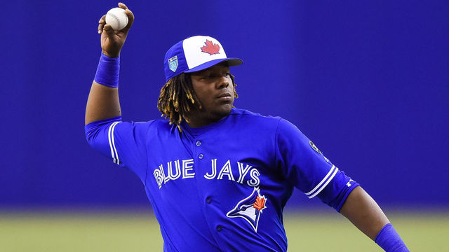 MONTREAL, QC - MARCH 27: Toronto Blue Jays infielder Vladimir Guerrero Jr. (27) pitches the ball during the St. Louis Cardinals versus the Toronto Blue Jays spring training game on March 27, 2018, at Olympic Stadium in Montreal, QC