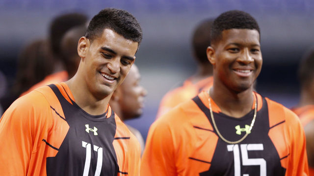 INDIANAPOLIS, IN - FEBRUARY 21: Quarterbacks Marcus Mariota of Oregon and Jameis Winston of Florida State look on during the 2015 NFL Scouting Combine at Lucas Oil Stadium on February 21, 2015 in Indianapolis, Indiana.