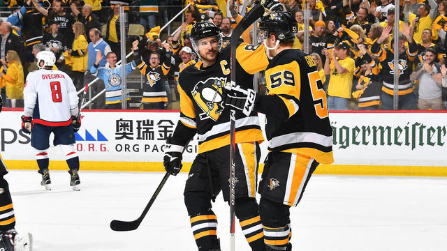 PITTSBURGH, PA - MAY 03: Jake Guentzel #59 of the Pittsburgh Penguins celebrates with Sidney Crosby #87 of the Pittsburgh Penguins after scoring in the third period against the Washington Capitals in Game Four of the Eastern Conference Second Round during the 2018 NHL Stanley Cup Playoffs at PPG Paints Arena on May 3, 2018 in Pittsburgh, Pennsylvania.