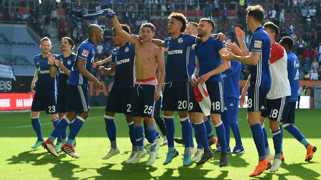 Schalke's players celebrate after the German first division Bundesliga football match FC Augsburg vs Schalke 04 in Augsburg, southern Germany, on May 5, 2018. - Schalke won 2-1.