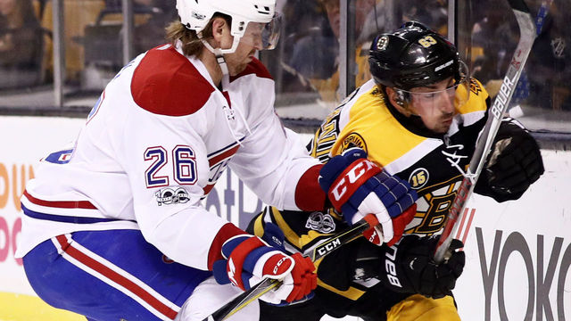 BOSTON, MA - FEBRUARY 12: Jeff Petry #26 of the Montreal Canadiens checks Brad Marchand #63 of the Boston Bruins into the boards during the first period at TD Garden on February 12, 2017 in Boston, Massachusetts.