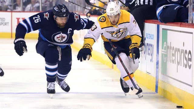WINNIPEG, MB - MAY 7: Blake Wheeler #26 of the Winnipeg Jets and Viktor Arvidsson #33 of the Nashville Predators chase the puck down the ice during first period action in Game Six of the Western Conference Second Round during the 2018 NHL Stanley Cup Playoffs at the Bell MTS Place on May 7, 2018 in Winnipeg, Manitoba, Canada.