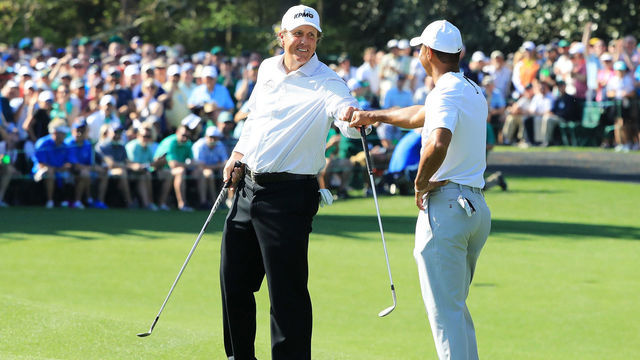 AUGUSTA, GA - APRIL 03: Tiger Woods and Phil Mickelson of the United States fist bump during a practice round prior to the start of the 2018 Masters Tournament at Augusta National Golf Club on April 3, 2018 in Augusta, Georgia.