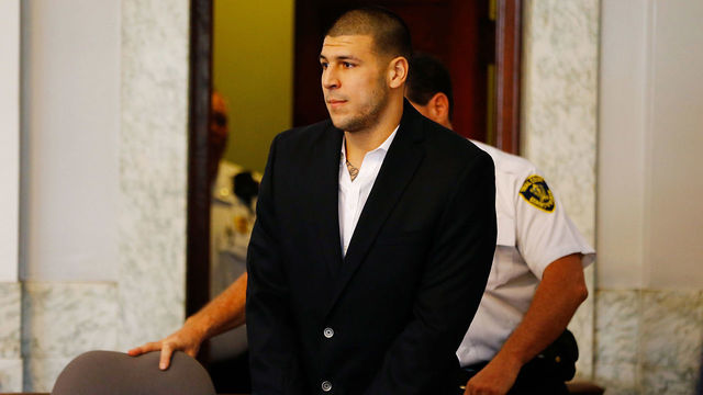 NORTH ATTLEBORO, MA - AUGUST 22: Aaron Hernandez is escorted into the courtroom of the Attleboro District Court for his hearing on August 22, 2013 in North Attleboro, Massachusetts. Former New England Patriot Aaron Hernandez has been indicted on a first-degree murder charge for the death of Odin Lloyd.