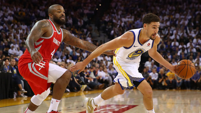 OAKLAND, CA - OCTOBER 17: Klay Thompson #11 of the Golden State Warriors drives to the hoop against PJ Tucker #4 of the Houston Rockets during their NBA game at ORACLE Arena on October 17, 2017 in Oakland, California.