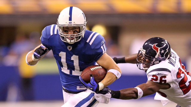 INDIANAPOLIS - NOVEMBER 01: Anthony Gonzalez #11 of Indianapolis Colts runs with the ball while defended by Eugene Wilson #26 of the Houston Texans during the NFL game at Lucas Oil Stadium on November 1, 2010 in Indianapolis, Indiana.
