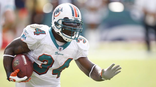 MIAMI - JANUARY 4: Ricky Williams #34 of the Miami Dolphins carries the ball during an AFC Wild Card playoff game against the Baltimore Ravens on January 4, 2009 at Dolphin Stadium in Miami, Florida.