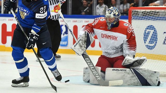 Finland's Janne Pesonen (L) leads a puck watched by Denmark's Frederik Andersen during the group B match Finland vs Denmark of the 2018 IIHF Ice Hockey World Championship at the Jyske Bank Boxen in Herning, Denmark, on May 9, 2018.