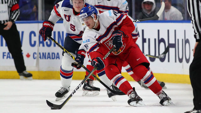 BUFFALO, NY - JANUARY 5: Martin Kaut #16 of Czech Republic with the puck as Trent Frederic #34 of United States defends in the first period during the Bronze Medal Game of the IIHF World Junior Championship at KeyBank Center on January 5, 2018 in Buffalo, New York.
