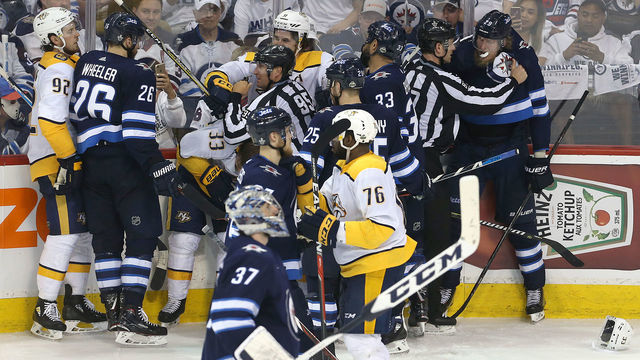 WINNIPEG, MANITOBA - MAY 7: Patrik Laine #29 of the Winnipeg Jets is held back by a linesman after the fourth goal by the Nashville Predators in Game Six of the Western Conference Second Round during the 2018 NHL Stanley Cup Playoffs on May 7, 2018 at Bell MTS Place in Winnipeg, Manitoba, Canada.