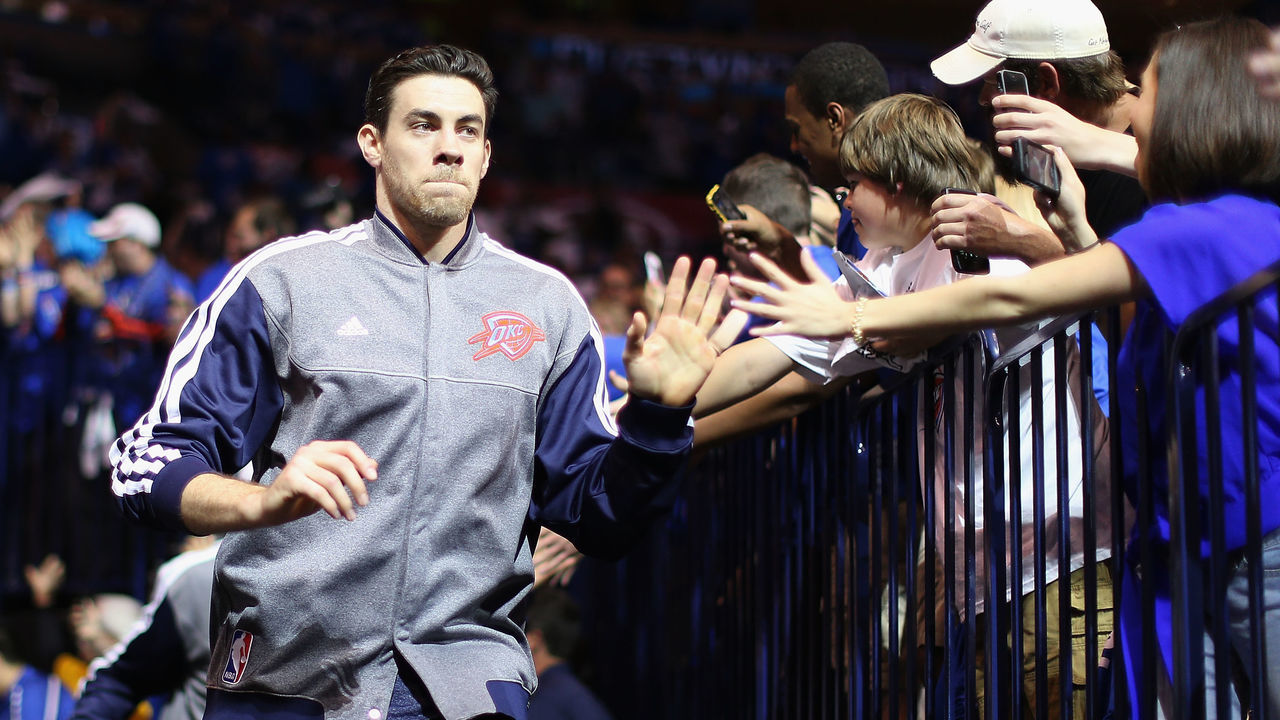 OKLAHOMA CITY, OK - APRIL 21: Nick Collison #4 of the Oklahoma City Thunder high-fives fans as he runs out onto the court before Game One of the Western Conference Quarterfinals of the 2013 NBA Playoffs against the Houston Rockets at Chesapeake Energy Arena on April 21, 2013 in Oklahoma City, Oklahoma. The Thunder defeated the Rockets 120-91.