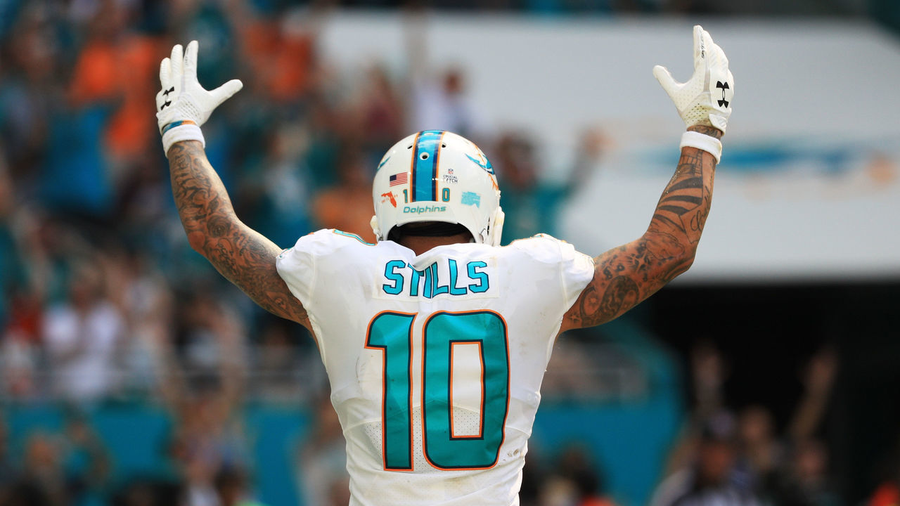 MIAMI GARDENS, FL - OCTOBER 08: Kenny Stills #10 of the Miami Dolphins celebrates a touchdown by Jarvis Landry #14 in the fourth quarter against the Tennessee Titans on October 8, 2017 at Hard Rock Stadium in Miami Gardens, Florida.