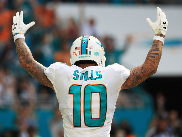 MIAMI GARDENS, FL - OCTOBER 08: Kenny Stills #10 of the Miami Dolphins celebrates a touchdown by Jarvis Landry #14 in the fourth quarter against the Tennessee Titans on October 8, 2017 at Hard Rock Stadium in Miami Gardens, Florida.