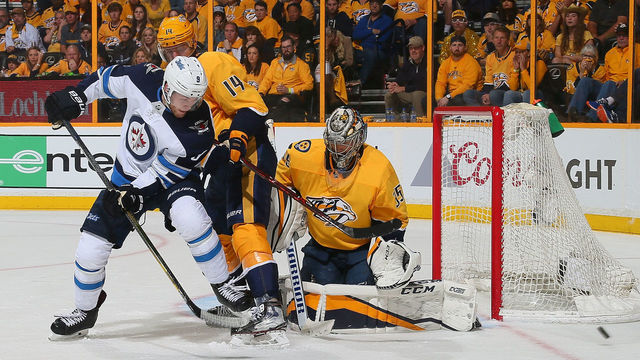 NASHVILLE, TN - MAY 05: Andrew Copp #9 of the Winnipeg Jets shoots the puck wide of Mattias Ekholm #14 and Pekka Rinne #35 of the Nashville Predators during the second period of Game Five of the Western Conference Second Round during the 2018 NHL Stanley Cup Playoffs at Bridgestone Arena on May 5, 2018 in Nashville, Tennessee.