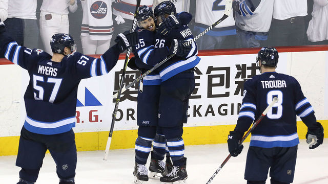 WINNIPEG, MANITOBA - MAY 1: Mark Scheifele #55 congratulates Blake Wheeler #26 of the Winnipeg Jets on his empty-net goal against the Nashville Predators in Game Three of the Western Conference Second Round during the 2018 NHL Stanley Cup Playoffs on May 1, 2018 at Bell MTS Place in Winnipeg, Manitoba, Canada.