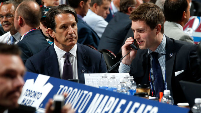 SUNRISE, FL - JUNE 26: Kyle Dubas Assistant General Manager of the Toronto Maple Leafs talks on the phone as President Brendan Shanahan looks on during the first round of the 2015 NHL Draft at BB&T Center on June 26, 2015 in Sunrise, Florida.