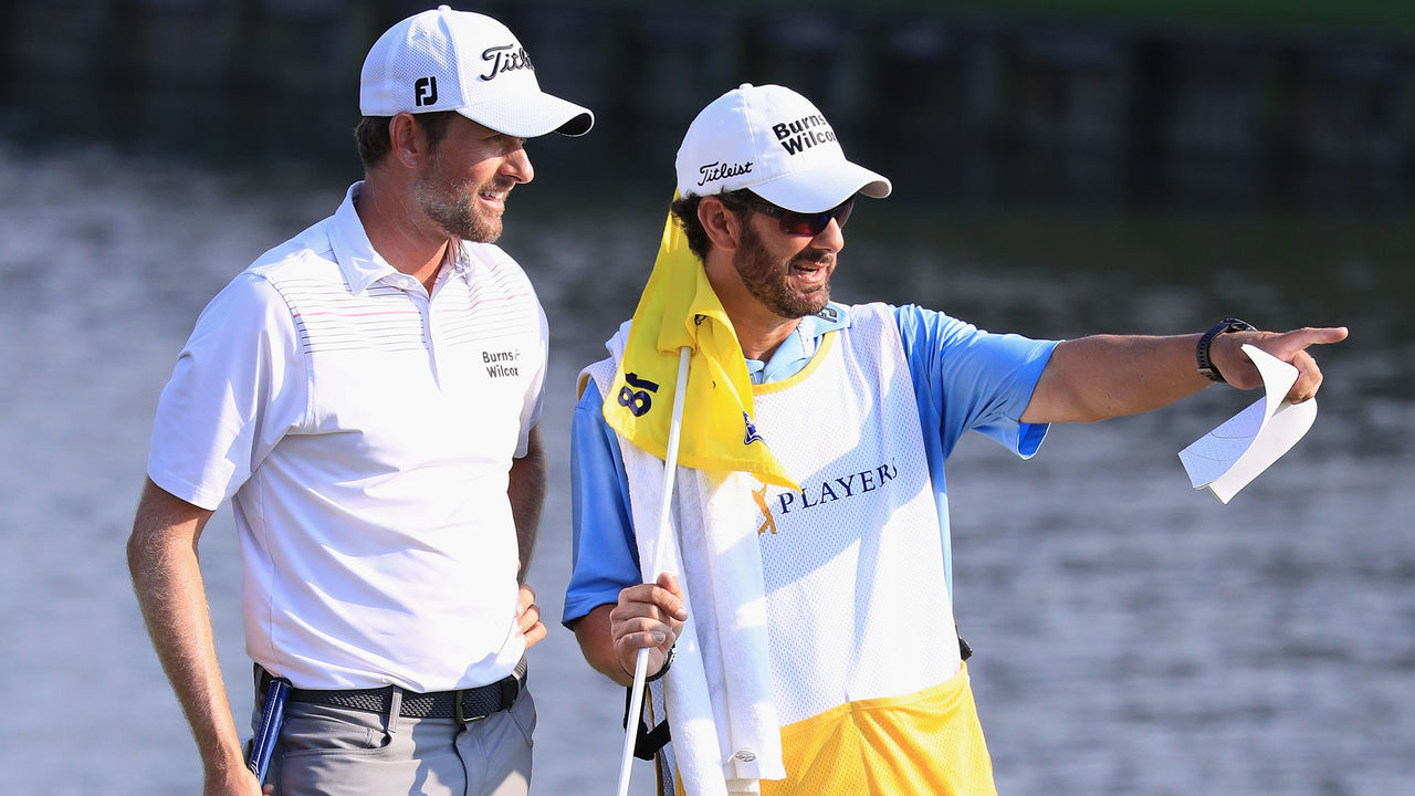 PONTE VEDRA BEACH, FL - MAY 11: Webb Simpson of the United States talks with his caddie on the 18th green during the second round of THE PLAYERS Championship on the Stadium Course at TPC Sawgrass on May 11, 2018 in Ponte Vedra Beach, Florida.