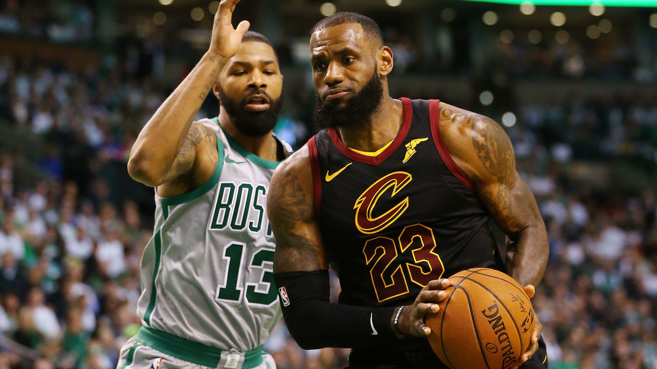 BOSTON, MA - FEBRUARY 11: Lebron James #23 of the Cleveland Cavaliers drives to the basket past Marcus Morris #13 of the Boston Celtics during the first quarter of a game at TD Garden on February 11, 2018 in Boston, Massachusetts.